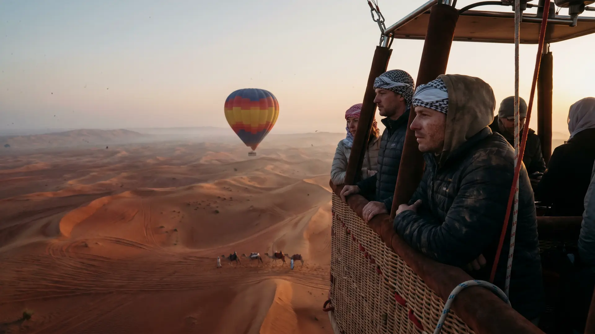 Hot air balloon rising over the Dubai desert at sunrise